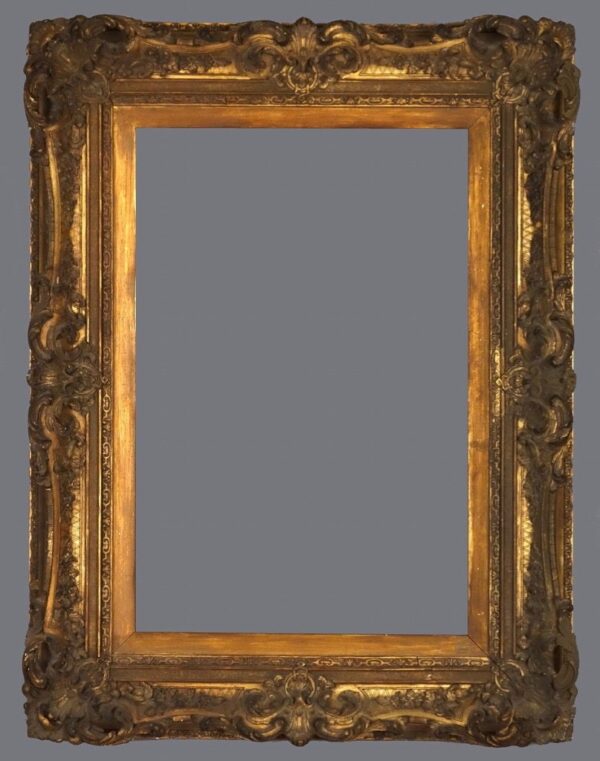 A picture frame with gold leaf and a gray background.