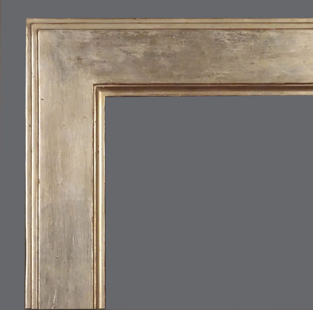 A silver picture frame with a gray background.