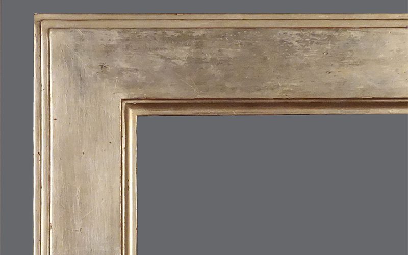 A picture frame with the corner of it in grey.