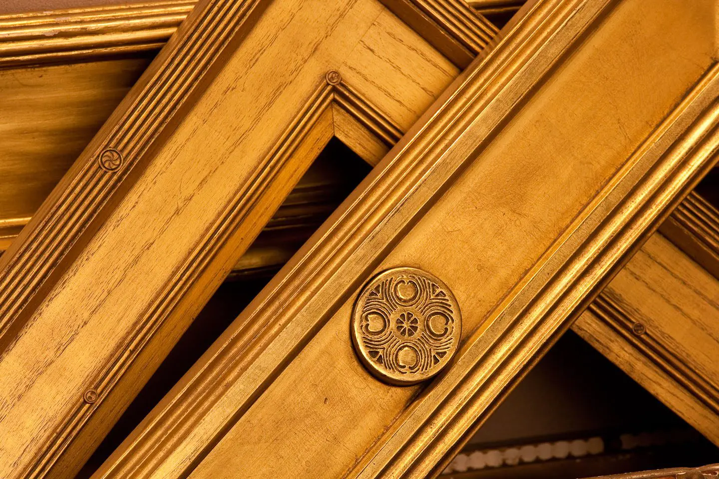 A close up of some wooden frames with a round button