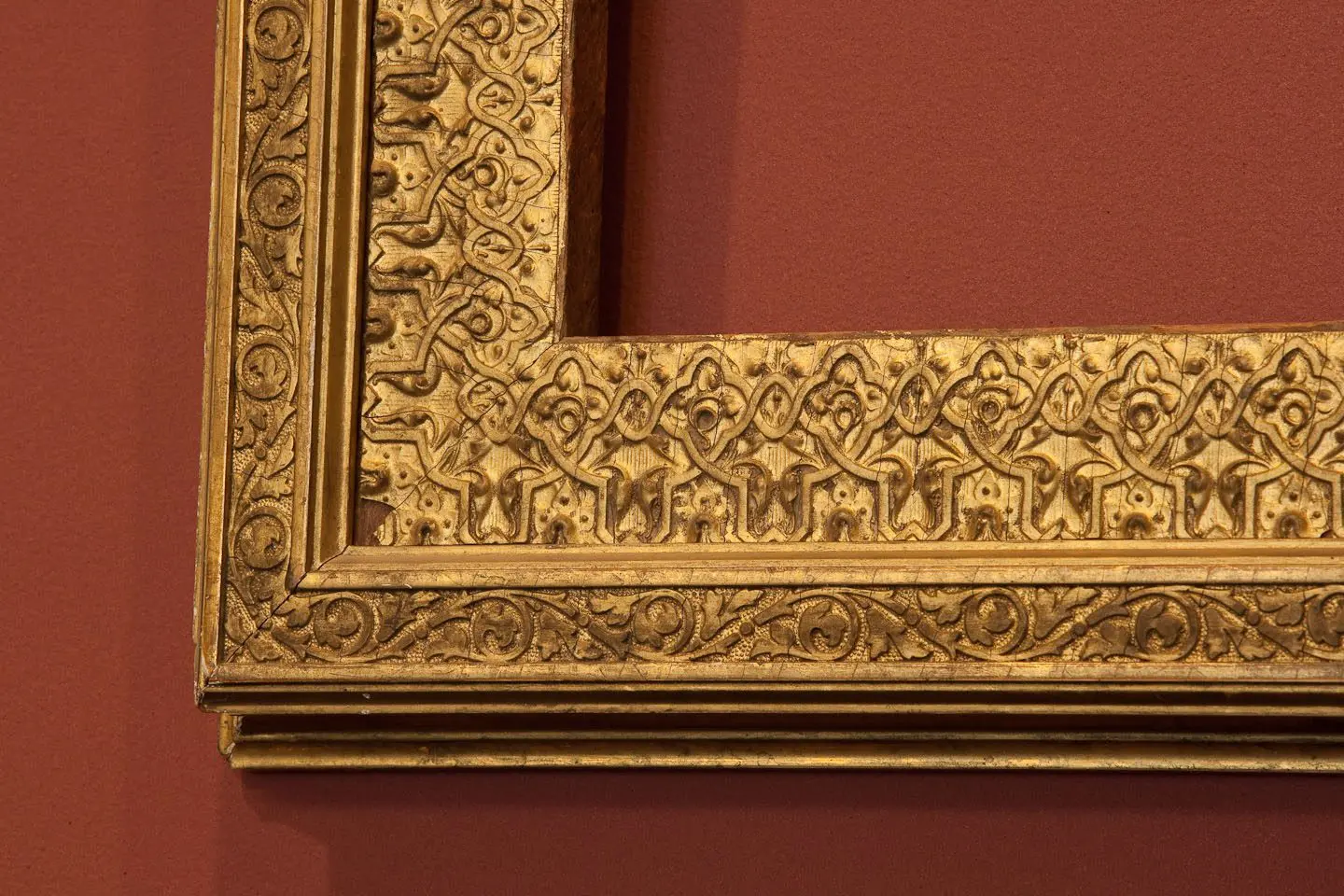 A gold frame with intricate designs on it.