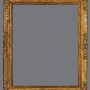 A picture frame with an ornate gold finish.