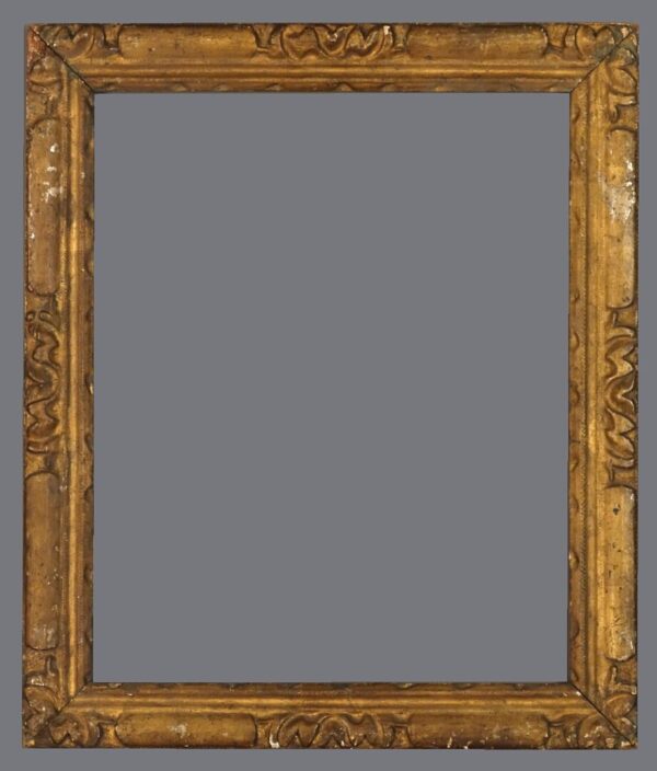 A picture frame with an ornate gold finish.