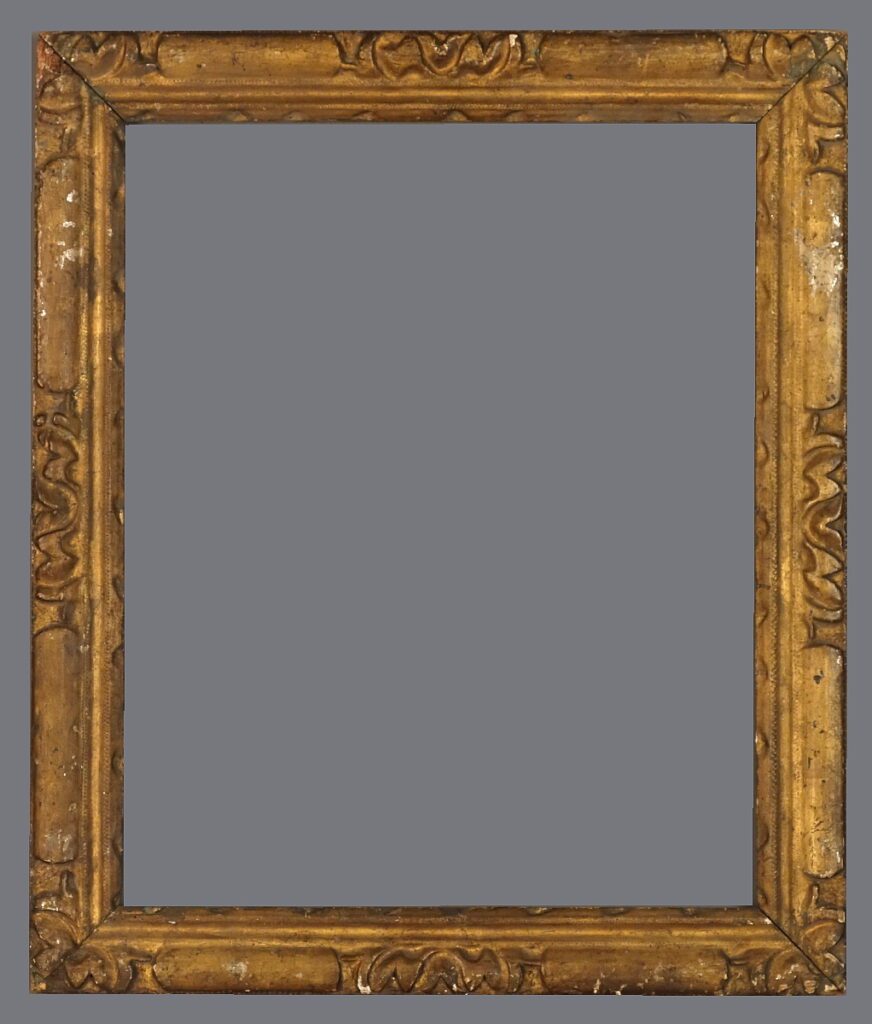 A picture frame with an ornate gold finish.