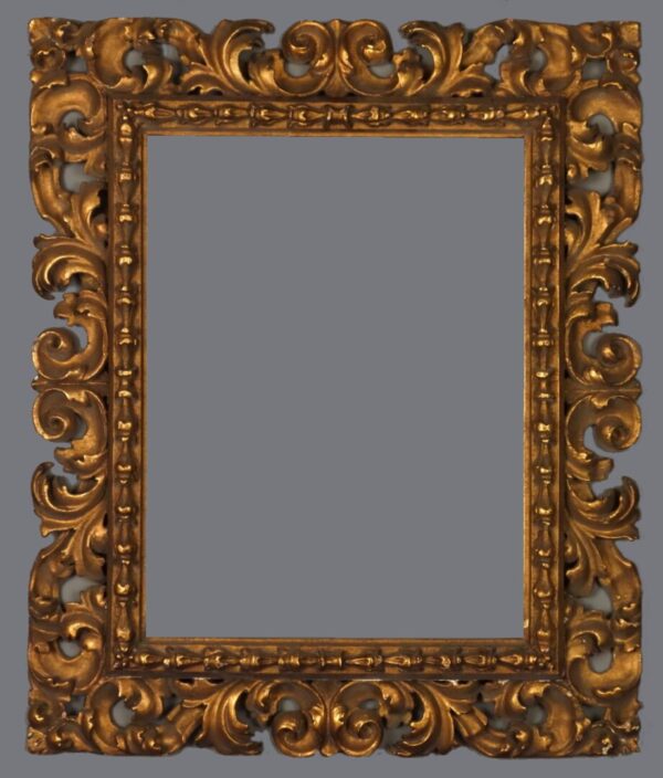 A picture frame with gold leaf and ornate design.