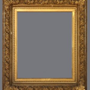 A picture frame with gold leaf and a gray background.