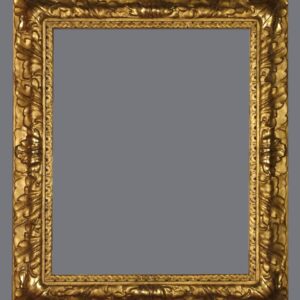 A picture frame with gold leaf and an ornate design.