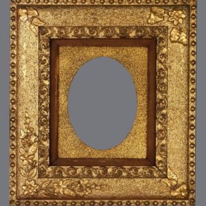 A gold frame with a mirror in the middle of it.