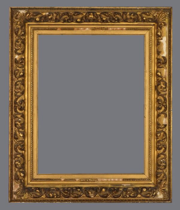 A picture frame with gold leaf and a gray background.