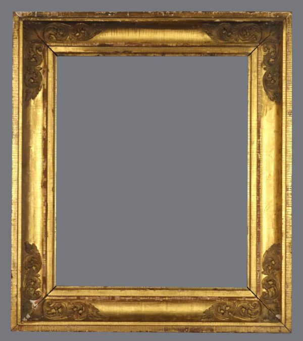 A picture frame with gold leaf and a gray background.