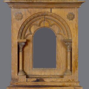 A wooden cabinet with a mirror and two pillars.