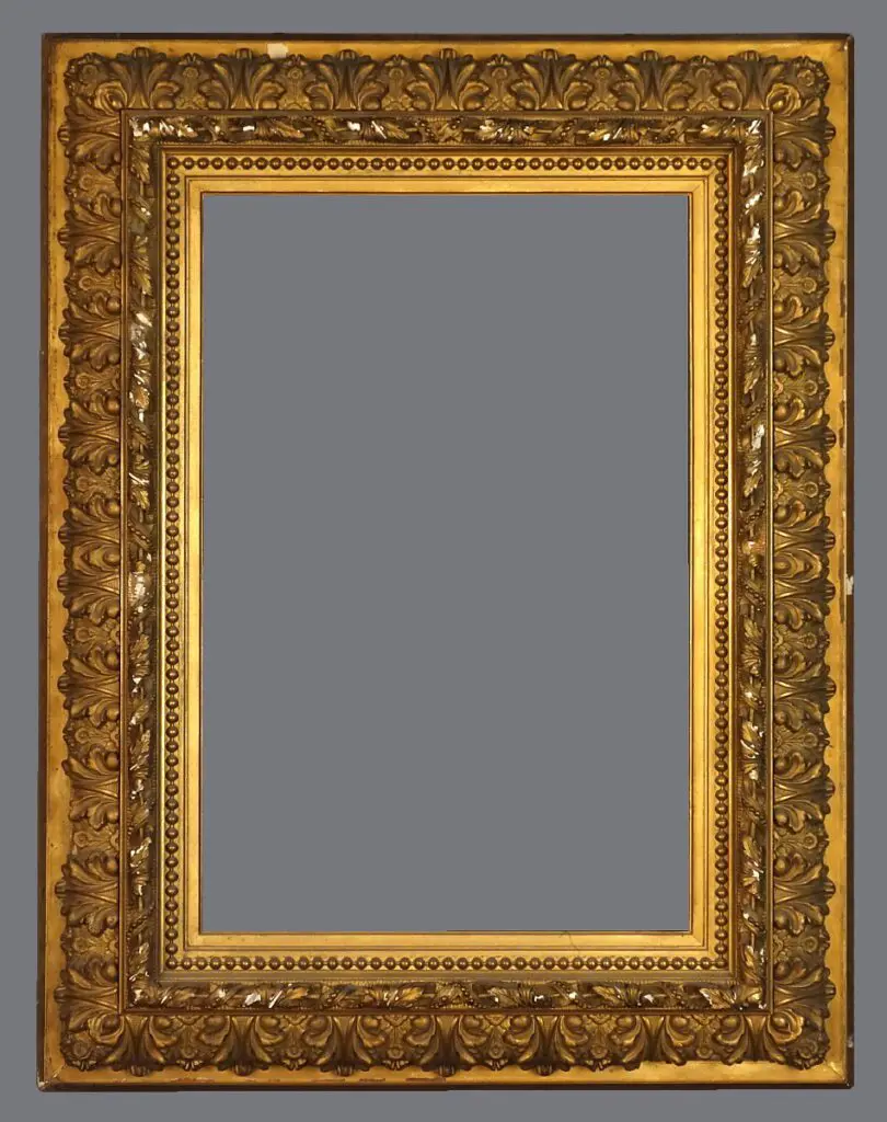 A picture frame with gold leaf and ornate design.