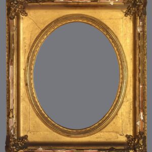 A gold frame with an oval mirror in the center.