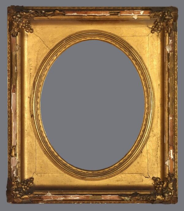 A gold frame with an oval mirror in the center.