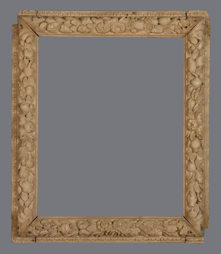 A picture frame with many small shells on it.