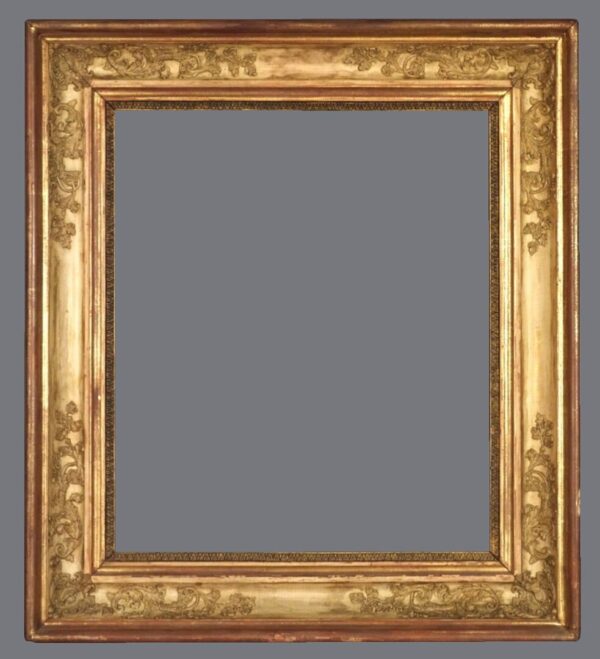 A picture frame with gold leaf and a gray background.