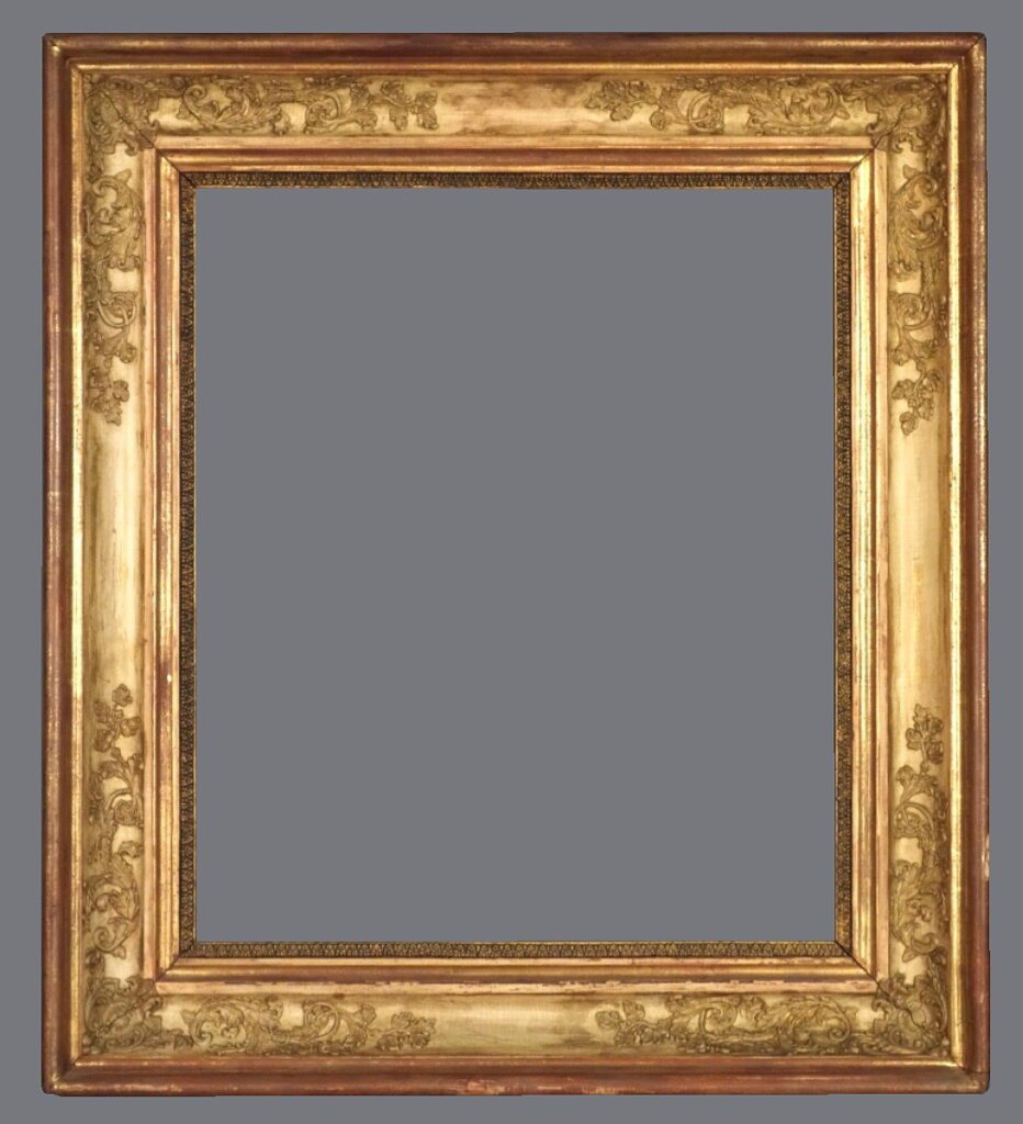 A picture frame with gold leaf and a gray background.