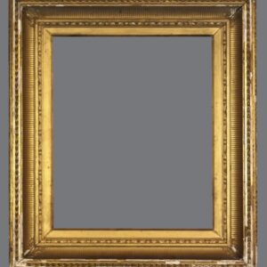 A picture frame with gold leaf and an ornate design.