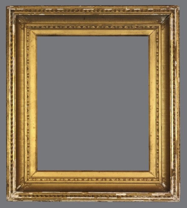 A picture frame with gold leaf and an ornate design.