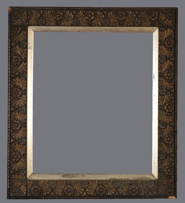 A mirror with a gold frame and a black background