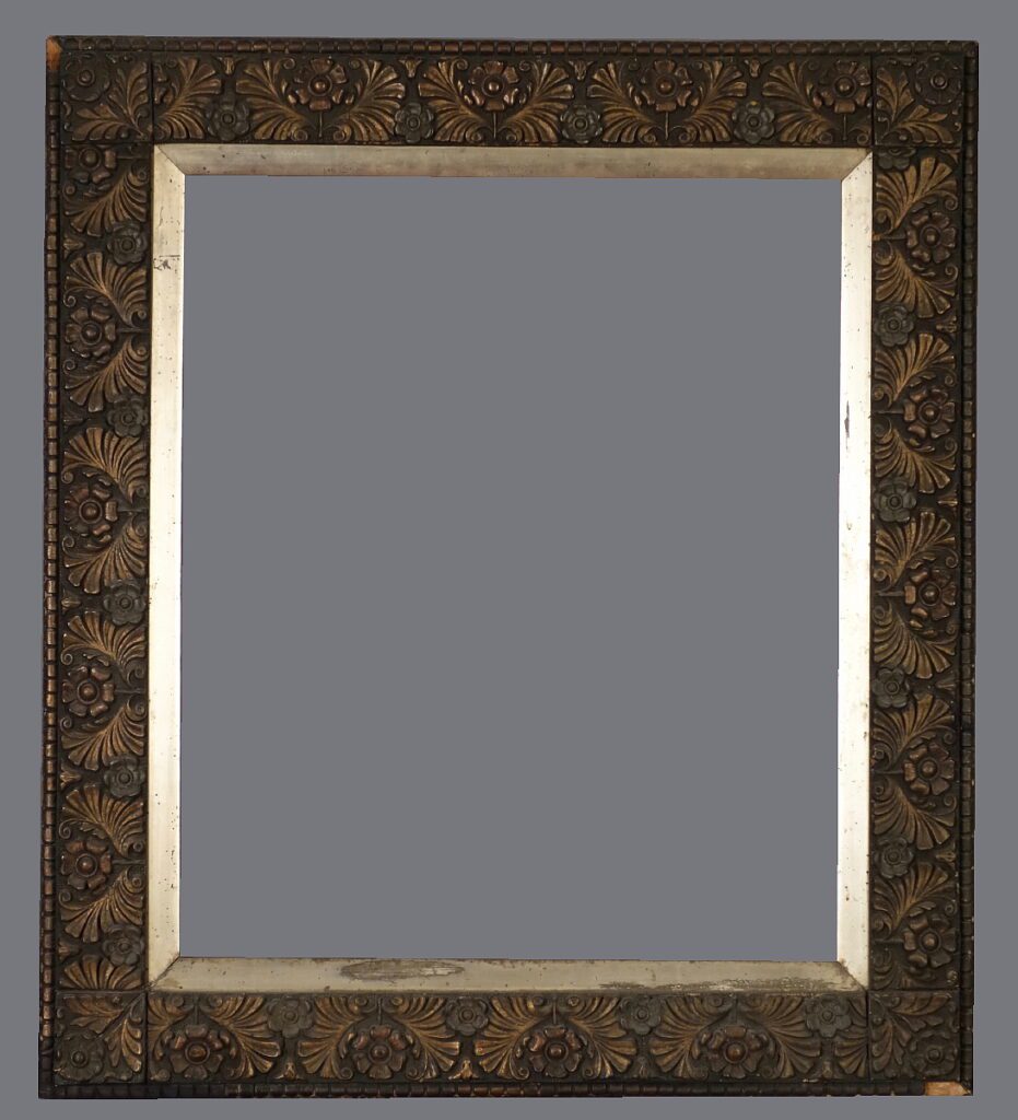 A mirror with a gold frame and a black background