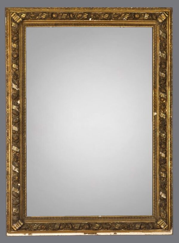 A mirror with gold frame and white background