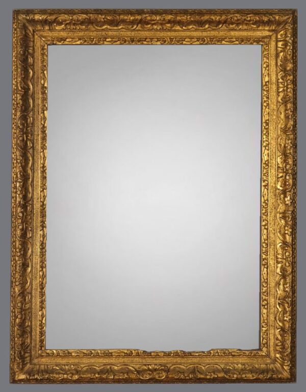 A gold framed mirror with a white background