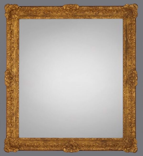 A mirror with a gold frame and gray background