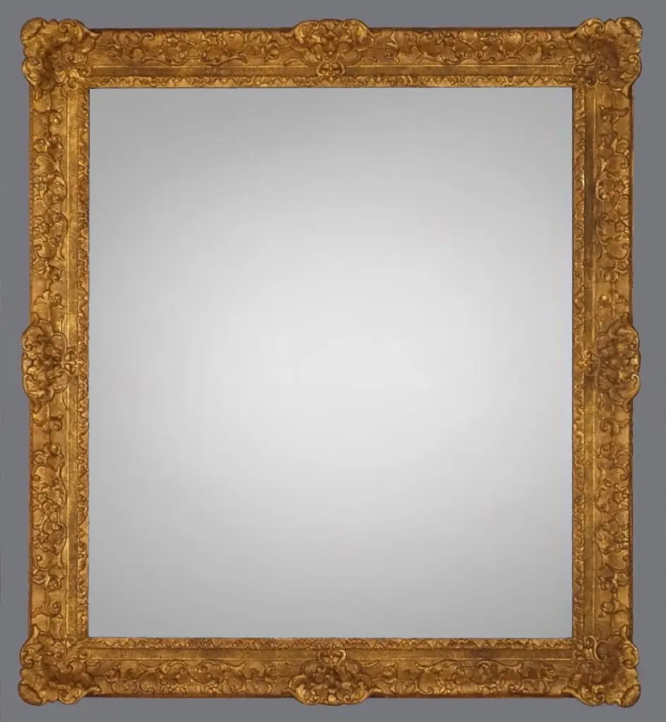 A mirror with a gold frame and gray background