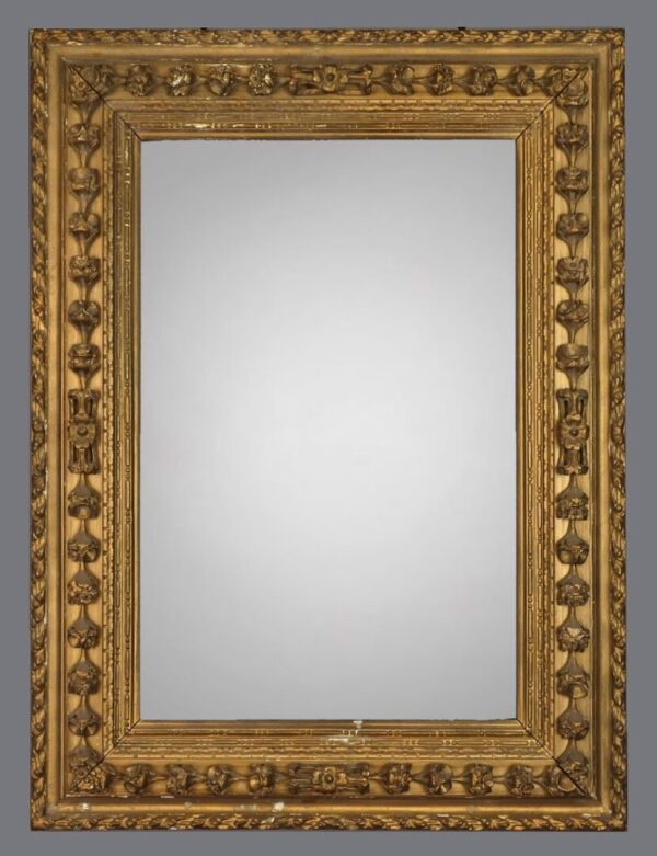 A mirror with gold frame and white background