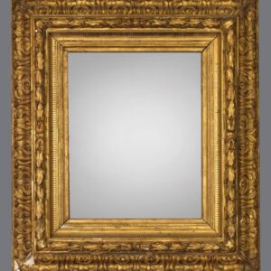 A gold frame with a mirror on the side.