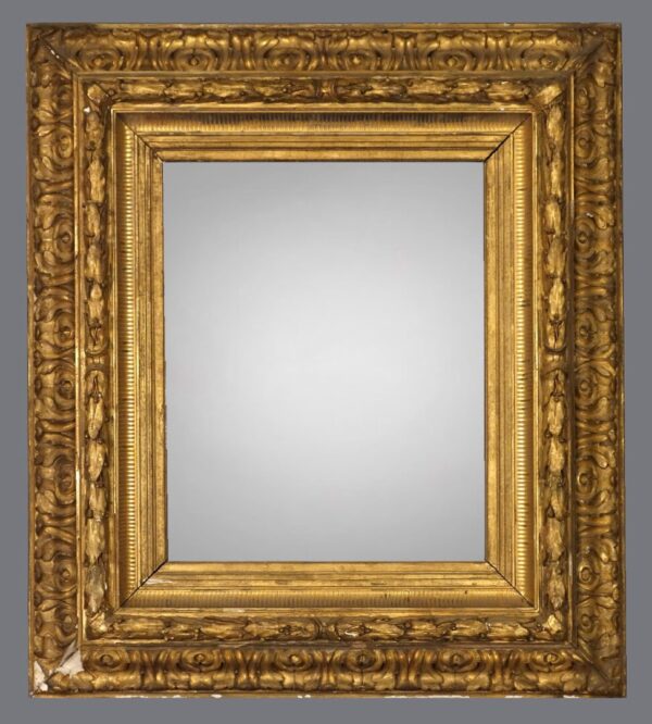 A gold frame with a mirror on the side.