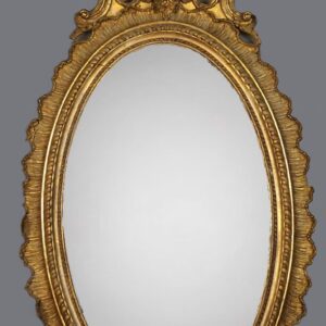 A gold mirror with an ornate frame and a gray background.