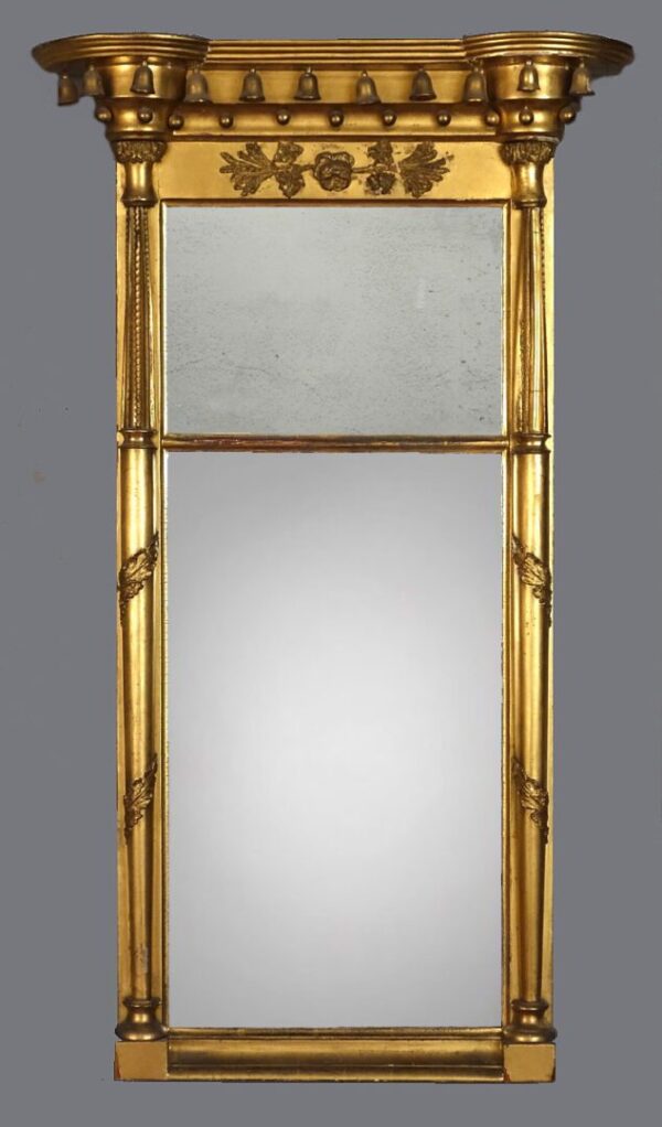 A gold mirror with two mirrors on the side.