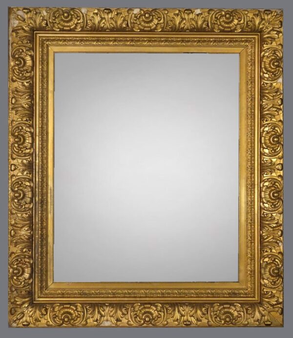 A gold frame with a mirror on the side.