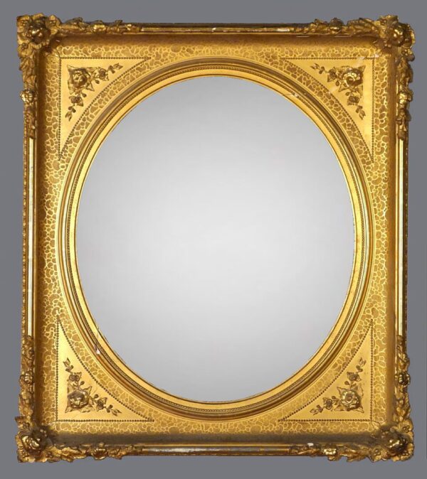 A gold frame with a mirror on the side.