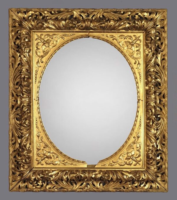 A gold frame with a mirror on the wall