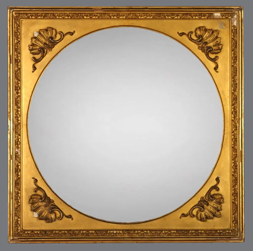 A mirror with a gold frame and a brown design.