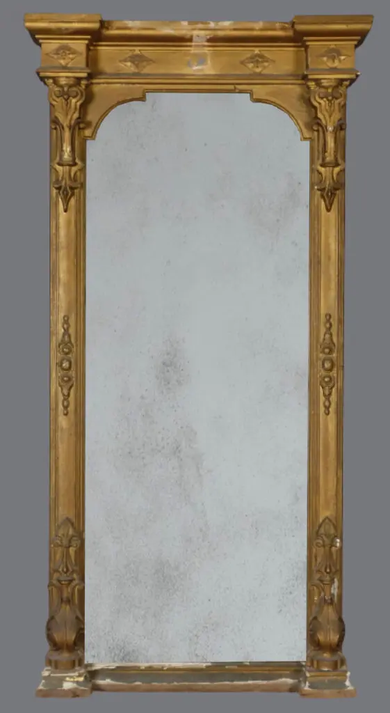 A large mirror with gold frame and white marble