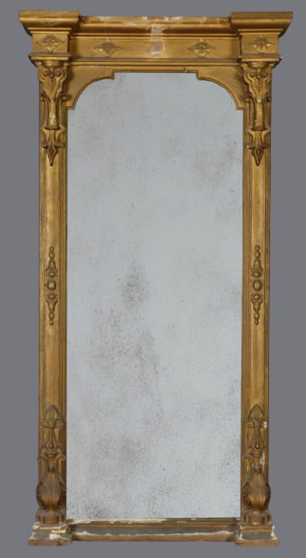 A large mirror with gold frame and white marble