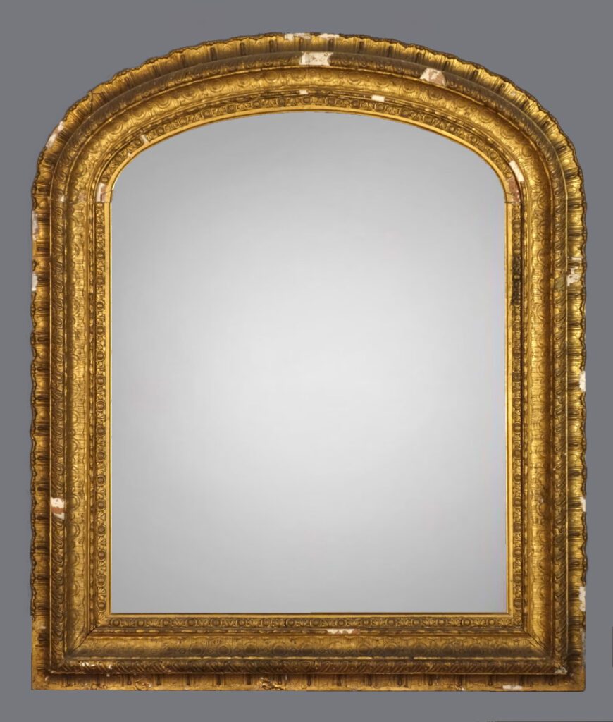 A mirror with gold frame and gray background